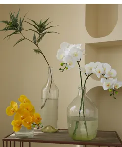 Artificial Phalaenopsis orchid flowers in glass vases, perfect for home indoor decor.