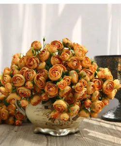 Detailed view of 15-head artificial camellia flower bouquet in ceramic vase for home decor.