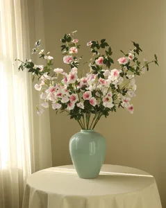 Artificial morning glory flowers in ceramic vase indoor pastoral home decor floral arrangement.