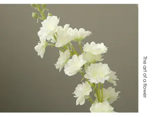 Close-up detail of artificial white delphinium flower branch, perfect for home decor display.