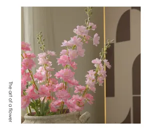 Artificial pink delphinium flowers in rustic pot for home living room hotel hotel decoration.