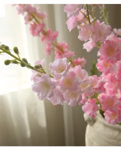 Artificial pink flower detail shot, home decor blossom branch close-up for room styling.