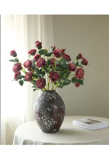 Artificial rose bouquet detail view, vintage dark pink faux flowers in vase for home decor.