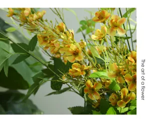 Artificial plum blossom flower branch detail for home indoor decoration and photography prop.