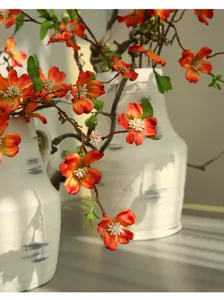 Artificial flower long branch retro ceramic vase home decor detail view for rustic room design.
