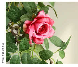 Artificial rose flower vine detail shot, pink floral garland for wall decoration.