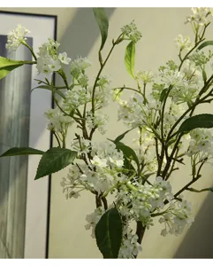 Artificial white flower branch close up indoor home decor floral arrangement detail