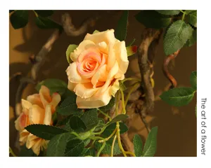 Artificial rose flower vine for wall decoration, realistic green leaves and branches.