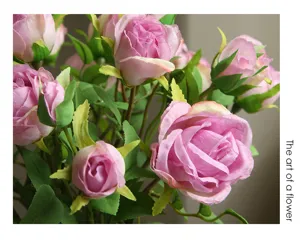 Close-up detail of artificial pink rose bouquet with green leaves for home decor and photo props.