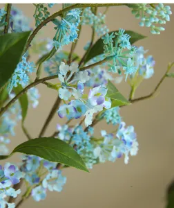 Artificial blue flower close-up detail, realistic faux floral branch for home decor and styling.
