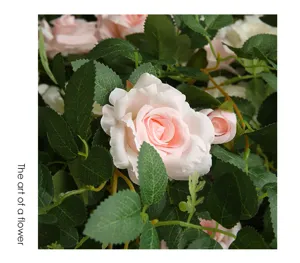 Artificial rose flower vine detail shot, pink floral home wall decor and piping wrap.