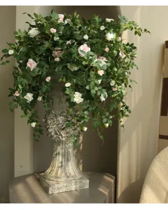 Artificial rose flower vine with retro Roman pillar vase for chic home wall decor.