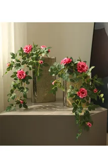 Artificial rose flower vine for home wall decor, elegant pink floral arrangement for room styling.