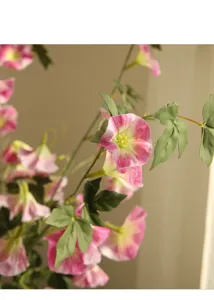 Detailed close-up of artificial pink morning glory flowers with green leaves for home decor.