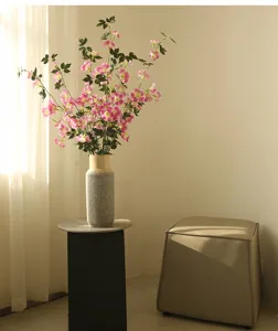 Detailed view of artificial morning glory flower arrangement in vase for home decor.