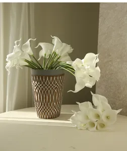 Artificial calla lily flower detail, white faux floral arrangement in rustic vase for home decor.