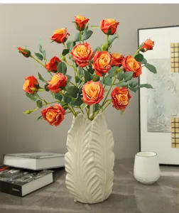 Artificial rose bouquet in ceramic vase, elegant Nordic style floral home table decor.