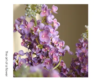 Artificial moisturizing purple lilac flowers close-up detail for home decor table display