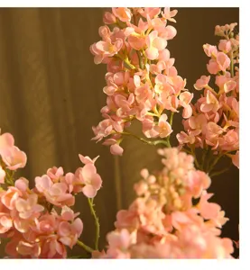 Close-up detail of artificial pink lilac flower branch, realistic texture, perfect for home decor.