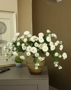 Artificial white peony flower arrangement in vintage vase for home decor interior styling.