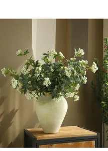 Artificial snowball flower arrangement in ceramic vase for modern home decor and interior styling.