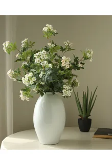 Nordic style artificial snowball flower bouquet in white ceramic vase for home decor detail.