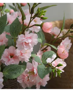 Artificial pink camellia silk flower bouquet for home dining table decoration close up