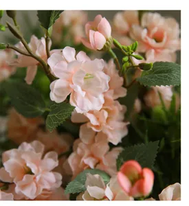 Artificial camellia flower bouquet detail, romantic pink silk floral decor for home table.