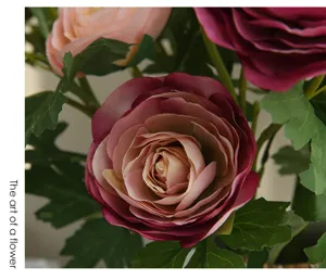 Artificial flower detail shot showing vibrant pink rose petals and realistic green leaves close up.