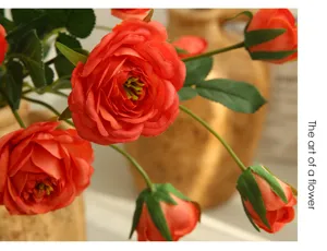 Artificial orange ranunculus flower bouquet for home living room hotel interior decoration.
