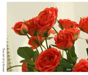 Detail shot of artificial red rose bouquet, vibrant red flower heads and green leaves for home decor.