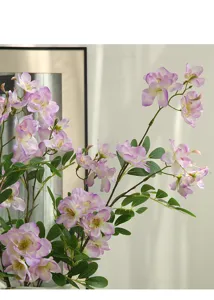 Primo piano dettagliato di un ramo di begonia artificiale con petali rosa e foglie verdi.