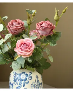 Artificial rose flower arrangement in ceramic vase for home decor and interior design