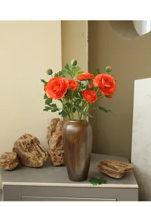 Detailed view of the artificial ranunculus flower bouquet in a vase, elegant home decor.