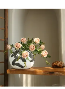 Elegant artificial rose flower arrangement with patterned ceramic vase for home decor.