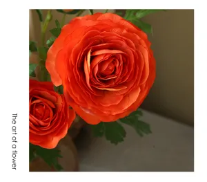 Closeup of orange artificial ranunculus flower detail, elegant home decor floral arrangement display.