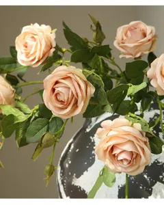 Artificial rose flower detail close-up, champagne pink fake floral arrangement for home decor.