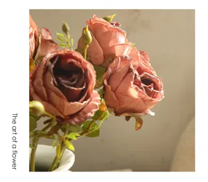 Closeup of vintage burnt-edge artificial rose flower arrangement, retro aesthetic floral decor.