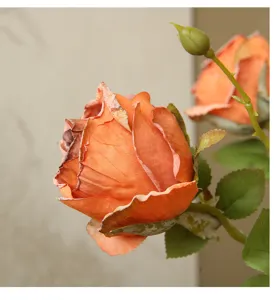 Artificial vintage orange rose flower close-up detail, retro home decor floral ornament