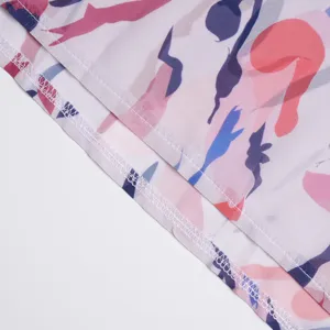 Close-up detail of women garment hemline showing neat white stitching and colorful abstract print.