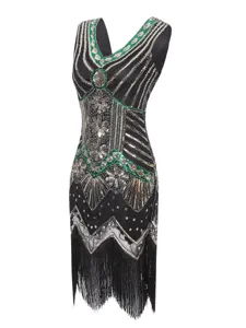 Close-up detail of 1920s vintage sequin beaded fringe dress featuring art deco pattern.