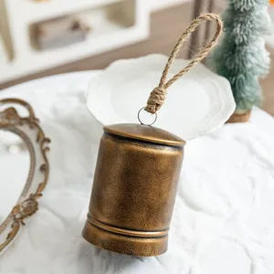 Vintage rustic iron Christmas hanging bell with jute rope for holiday home decor display.