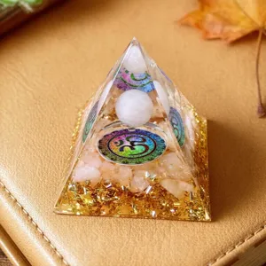 Crystal pyramid detail, resin ornament with pink quartz stones and spiritual symbol for home decor