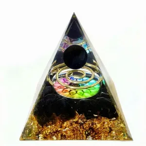 Resin orgonite pyramid crystal ornament detail, handmade natural stone healing energy decor.