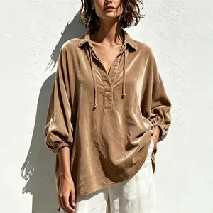 Velvet shirt detail view featuring V-neckline, adjustable drawstrings and elegant lantern sleeves.
