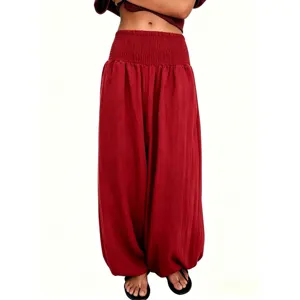 Détail de pantalon sarouel en lin rouge taille haute smocké avec un grand élastique