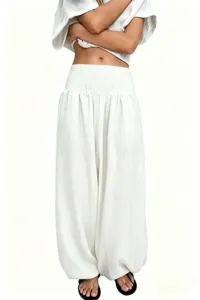 Gros plan sur le pantalon lanterne taille haute en lin et coton de couleur blanche.