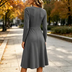 Back view detail showing the elegant solid grey long sleeve midi dress in autumn street.