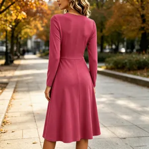 Detail shot of a solid long-sleeve midi dress featuring a stylish waist design.