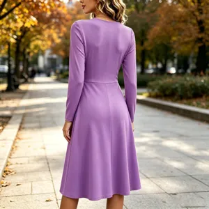 Detail view of the elegant purple long sleeve midi dress worn outdoors in an autumn park.
